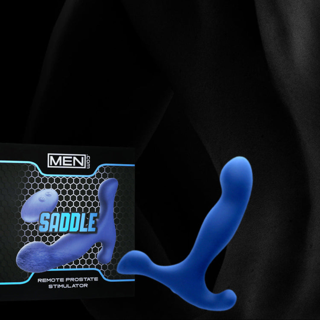 Blue remote-controlled prostate stimulator shown alongside its black and blue retail packaging box, set against a dark, shadowed male torso background.